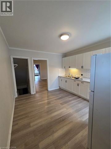 Hamilton apartment for rent - A kitchen with white cabinets and a refrigerator.