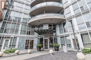 Toronto (Niagara) condo for rent - A modern building with a glass facade and a circular balcony.