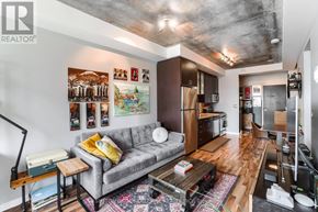 Toronto (Niagara) condo for rent - A living room with a grey couch and a coffee table.
