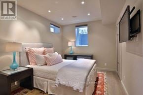 Toronto (Yonge-St. Clair) apartment for rent - A bedroom with a bed, two lamps, and a television.