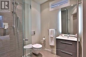 Toronto (Yonge-St. Clair) apartment for rent - A bathroom with a glass shower stall, toilet, and sink.