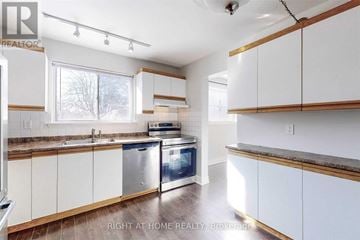 Richmond Hill (North Richvale) apartment for rent - A kitchen with white cabinets and a stainless steel oven.