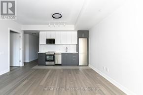 Toronto (University) condo for rent - A kitchen with a refrigerator, oven, and microwave.
