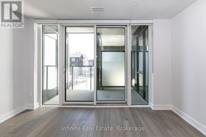 Toronto (University) condo for rent - A room with a glass door leading to a balcony.