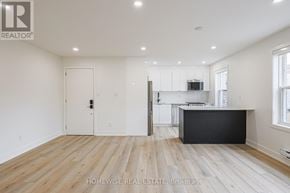 Toronto (Casa Loma) apartment for rent - A spacious room with wooden flooring and white walls.