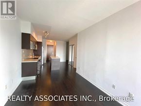 Toronto (Bay Street Corridor) condo for rent - A spacious room with a kitchen area and a dining table.