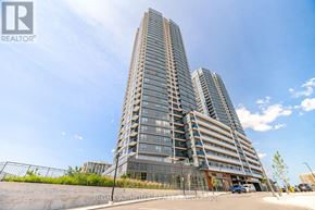Vaughan (Brownridge) condo for rent - A tall residential building with a glass facade stands under a clear blue sky.