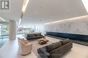 Vaughan (Brownridge) condo for rent - A modern living room with a marble wall and a large window.