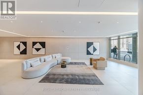 Vaughan (Brownridge) condo for rent - A spacious living room with a white sofa and a grey rug.