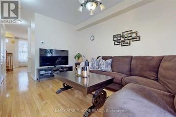 Richmond Hill (Jefferson) townhouse for rent - A living room with a brown couch and a wooden coffee table.