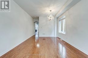 Oakville (Go Glenorchy) apartment for rent - A spacious room with wooden flooring and a chandelier hanging from the ceiling.