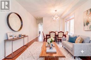 Oakville (Go Glenorchy) apartment for rent - A living room with a grey couch, a wooden coffee table, and a chandelier.