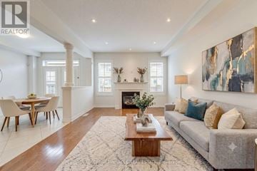 Oakville (Go Glenorchy) apartment for rent - A living room with a grey couch, a coffee table, and a painting on the wall.