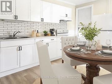 Hamilton (Landsdale) fourplex for rent - A white kitchen with a table set for two.