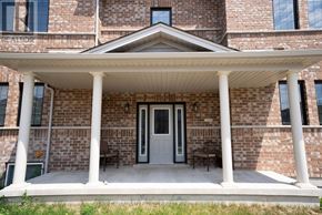 Kitchener apartment for rent - A brick building with a porch and a sign that says "REALTOR".