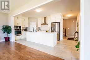 Kitchener apartment for rent - A modern kitchen with a white counter and wooden floors.
