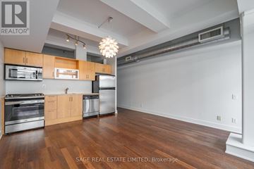 Toronto (South Riverdale) condo for rent - A kitchen with wood floors and stainless steel appliances.