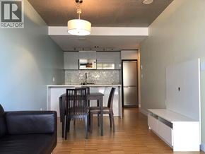 Vancouver apartment for rent - A modern kitchen with a dining table and chairs.
