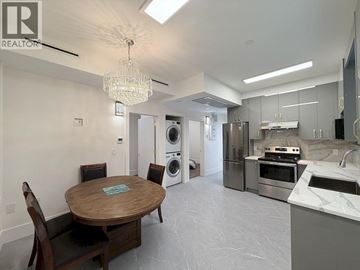 Vancouver apartment for rent - A modern kitchen with a wooden table and chairs.