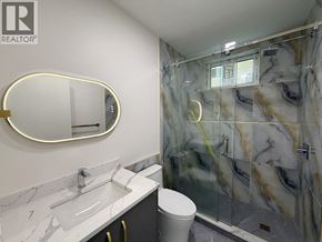 Vancouver apartment for rent - A bathroom with marble countertops and a walk-in shower.
