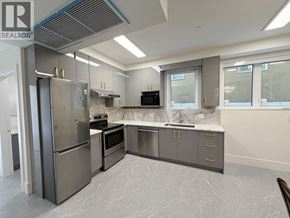 Vancouver apartment for rent - A modern kitchen with stainless steel appliances and marble flooring.
