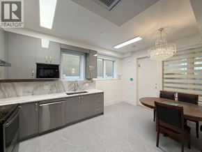 Vancouver apartment for rent - A modern kitchen with a dining table and chairs.