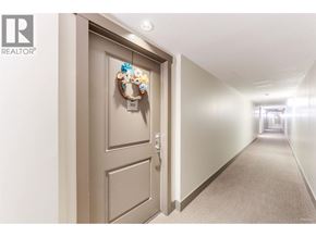 Burnaby apartment for rent - A hallway with a door on the left and a wreath on the door.