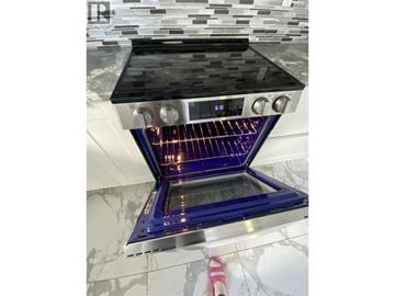 Vancouver apartment for rent - A modern kitchen with a stove top oven.