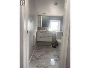 Vancouver apartment for rent - A bathroom with a marble floor and white walls.