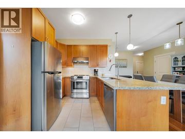 Vancouver apartment for rent - A kitchen with wooden cabinets and a stainless steel refrigerator.