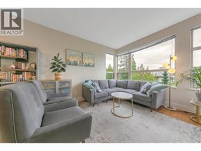 Vancouver apartment for rent - A living room with grey couches, a coffee table, and a bookshelf.
