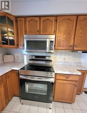 St. Catharines apartment for rent - A kitchen with wooden cabinets and a stainless steel oven.