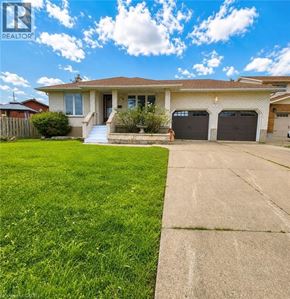 St. Catharines apartment for rent - A house with a brown roof and a white garage door.