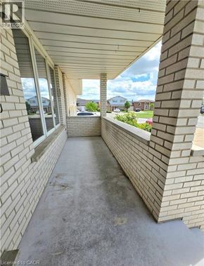 St. Catharines apartment for rent - A long concrete walkway between two brick walls.