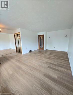 St. Catharines apartment for rent - A room with wooden flooring and two doors.