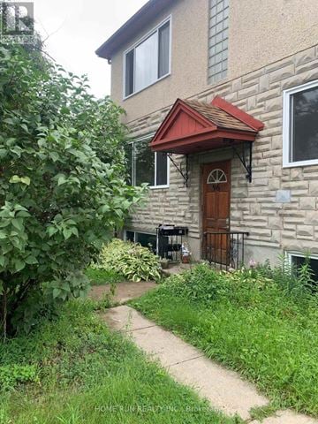 Ottawa triplex for rent - A house with a red awning and a brown door.