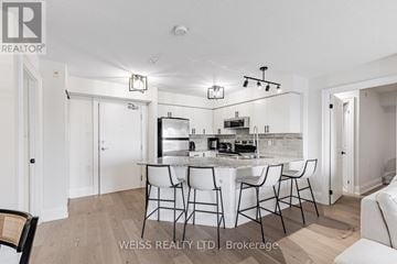 Toronto (Bathurst Manor) condo for rent - A dining area with a table and chairs is shown in the image.