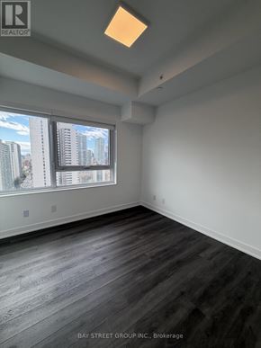 Toronto (North St. James Town) condo for rent - A room with a large window and wooden flooring.