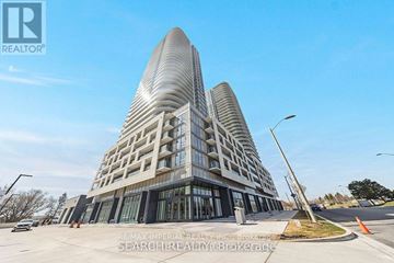 Toronto (Agincourt South-Malvern West) condo for rent - A modern building with a curved facade is the focal point of the image.
