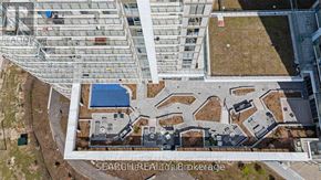Toronto (Agincourt South-Malvern West) condo for rent - An aerial view of a large building complex with a courtyard and a blue roofed structure.