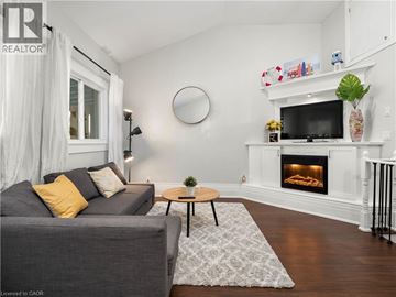 Hamilton apartment for rent - A living room with a grey couch and a fireplace.
