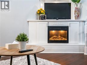 Hamilton apartment for rent - A living room with a fireplace and a flat screen TV mounted above it.