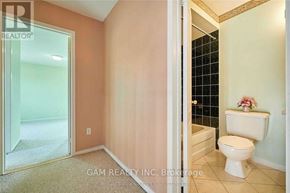 Mississauga (East Credit) townhouse for rent - A white toilet sits in a bathroom with a glass shower door.