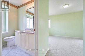 Mississauga (East Credit) townhouse for rent - A bathroom with a toilet, sink, and window.