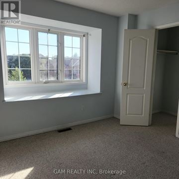 Mississauga (East Credit) townhouse for rent - A kitchen with white countertops and wooden cabinets.