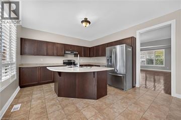 Cambridge apartment for rent - A kitchen with brown cabinets and a white countertop.