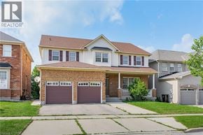 Cambridge apartment for rent - A house with a brown garage door is for sale.