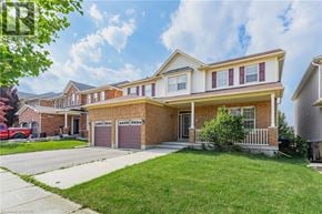 Cambridge apartment for rent - A two-story house with a red car parked in the driveway.
