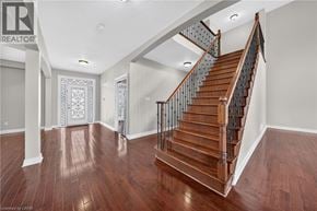 Cambridge apartment for rent - A wooden staircase with a metal railing in a house.