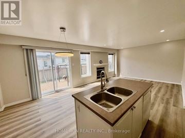 Ottawa townhouse for rent - A kitchen with a sink and a window.